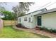 View of backyard with a new wooden fence and a brick walkway leading to a door at 701 38Th N Ave, St Petersburg, FL 33704