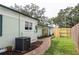The brick walkway in backyard leads along the side of the house and a new wooden fence at 701 38Th N Ave, St Petersburg, FL 33704