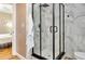 Beautiful bathroom featuring a modern shower with black trim and sleek hardware and white marble-style tile at 701 38Th N Ave, St Petersburg, FL 33704