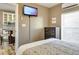 Bright bedroom with a view into the kitchen, featuring a dresser, wall-mounted TV, and comfortable bed at 701 38Th N Ave, St Petersburg, FL 33704