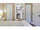 Cozy bedroom with access to a bathroom, featuring wood floors and plenty of closet space at 701 38Th N Ave, St Petersburg, FL 33704