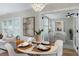 Chic dining area adjacent to the living room, showcasing modern decor, a stylish chandelier, and views of the bedroom at 701 38Th N Ave, St Petersburg, FL 33704