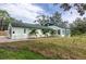 Charming home with green roof and shutters, nicely landscaped with tropical palms in the front yard at 701 38Th N Ave, St Petersburg, FL 33704