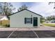 Side of house with extended driveway and parking space leads to the green front door at 701 38Th N Ave, St Petersburg, FL 33704