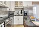 Stylish kitchen featuring stainless steel appliances, black countertops, and a convenient island with seating at 701 38Th N Ave, St Petersburg, FL 33704