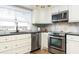 Well-lit kitchen featuring updated cabinets, granite countertops, and stainless steel appliances at 701 38Th N Ave, St Petersburg, FL 33704