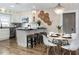 Eat-in kitchen with white cabinetry, stainless appliances, breakfast bar, and decorative chandelier at 701 38Th N Ave, St Petersburg, FL 33704