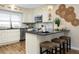 Kitchen with stainless appliances, bar seating, granite counters and stylish décor at 701 38Th N Ave, St Petersburg, FL 33704