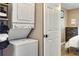 Stackable laundry center with washer and dryer situated next to a door and bedroom space at 701 38Th N Ave, St Petersburg, FL 33704