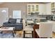 Cozy living space featuring a black leather sofa, coffee table and an inviting kitchen area with bar stool seating at 701 38Th N Ave, St Petersburg, FL 33704