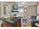 Comfortable living space with a marble fireplace, wall-mounted TV, and an island with seating at 701 38Th N Ave, St Petersburg, FL 33704