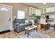 Cozy living room with modern furniture, adjacent to the kitchen and breakfast nook with updated appliances at 701 38Th N Ave, St Petersburg, FL 33704