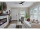 Bright living room featuring hardwood floors, a modern fireplace, and a comfortable white sofa with stylish accents at 701 38Th N Ave, St Petersburg, FL 33704