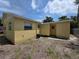 Exterior view of the backyard with yellow siding at 718 Paris S Ave, St Petersburg, FL 33701