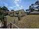 Side view of a charming home with a well-maintained lawn and a chain-link fence at 718 Paris S Ave, St Petersburg, FL 33701