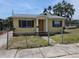 Charming single-story home featuring a fenced yard, yellow paint, and a welcoming front porch at 718 Paris S Ave, St Petersburg, FL 33701