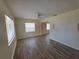 Spacious living room with wood-look flooring and arched doorway at 718 Paris S Ave, St Petersburg, FL 33701