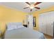 Bright bedroom featuring a ceiling fan, neutral carpet, and a double door closet for ample storage at 7203 55Th N Ave, St Petersburg, FL 33709