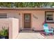 Charming home exterior featuring a front door and colorful chairs at 7203 55Th N Ave, St Petersburg, FL 33709