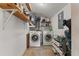 Laundry room featuring side-by-side washer and dryer, shelving, and other supplies at 7203 55Th N Ave, St Petersburg, FL 33709