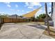 Spacious backyard featuring a concrete patio, shade sail, and wood fence at 7509 S West Shore Blvd, Tampa, FL 33616