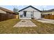 Backyard with a fire pit, small porch, and a well-maintained lawn at 7509 S West Shore Blvd, Tampa, FL 33616