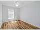 Bright, empty bedroom with ceiling fan and hardwood floors perfect for personalization at 7509 S West Shore Blvd, Tampa, FL 33616