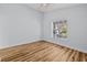 Comfortable bedroom featuring hardwood floors and a window letting in natural light at 7509 S West Shore Blvd, Tampa, FL 33616