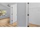 Clean bedroom features neutral paint, wood-look floors, and a walk-in closet at 7509 S West Shore Blvd, Tampa, FL 33616