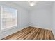This bedroom features a window and hardwood floors at 7509 S West Shore Blvd, Tampa, FL 33616