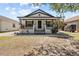 Charming single-story home with a covered front porch and a well-manicured yard at 7509 S West Shore Blvd, Tampa, FL 33616