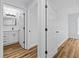 Hallway view into updated bathroom with modern vanity and lighting; entry into bedroom on the right at 7509 S West Shore Blvd, Tampa, FL 33616