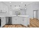A sleek white kitchen with stainless steel appliances and a breakfast bar at 7509 S West Shore Blvd, Tampa, FL 33616
