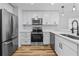 Updated kitchen featuring stainless appliances, ample white cabinetry, and modern finishes at 7509 S West Shore Blvd, Tampa, FL 33616
