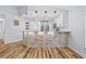 Bright, open living area with a stone-clad breakfast bar and a view into the modern kitchen at 7509 S West Shore Blvd, Tampa, FL 33616