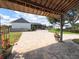 Stone back patio with flowers, string lights, and a view of the rear exterior of the house at 812 Jameson Rd, Lithia, FL 33547