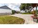 Expansive backyard features a stone patio, lush green lawn, and beautiful landscaping at 812 Jameson Rd, Lithia, FL 33547