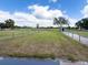 Large backyard with a well-maintained lawn, mature trees, fencing, and a small storage shed at 812 Jameson Rd, Lithia, FL 33547