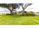 Beautiful backyard with bench, lush lawn, and mature trees, providing a relaxing outdoor space at 812 Jameson Rd, Lithia, FL 33547