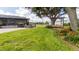 Lush backyard features a covered porch with furniture, bench, and beautiful landscaping at 812 Jameson Rd, Lithia, FL 33547