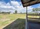 Expansive backyard with green grass, fencing, and shelter; blue skies and some clouds overhead at 812 Jameson Rd, Lithia, FL 33547
