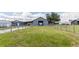 Barn with a large door is accessed by a long grassy drive fenced on both sides at 812 Jameson Rd, Lithia, FL 33547