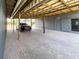 Covered carport area with brick floors, supports, gray wood siding, and an adjacent entry door at 812 Jameson Rd, Lithia, FL 33547