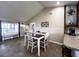 Cozy dining area adjacent to kitchen with tiled floor and decorative coffee cup metal art piece at 812 Jameson Rd, Lithia, FL 33547