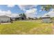 Beautiful exterior view of the property, featuring a manicured lawn, fenced yard, and outbuildings at 812 Jameson Rd, Lithia, FL 33547