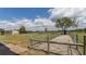 Exterior of property including side yard and pasture, featuring fencing and mature trees at 812 Jameson Rd, Lithia, FL 33547