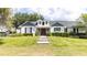 Charming home with a well-manicured lawn, symmetrical landscaping, and inviting brick pathway to the front door at 812 Jameson Rd, Lithia, FL 33547