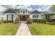 Beautiful home with dormer windows, a well-manicured lawn, and inviting walkway, framed by lush greenery at 812 Jameson Rd, Lithia, FL 33547