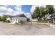 White exterior of home featuring small windows, grey trim, a fence and landscaping at 812 Jameson Rd, Lithia, FL 33547