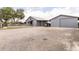 Exterior featuring a collection of modern barns and workshops, set within a well-maintained yard at 812 Jameson Rd, Lithia, FL 33547